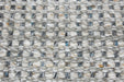 Close-up of a woven textile surface with a basketweave pattern in off-white, gray, and small blue and tan flecks.