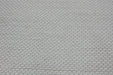 A close-up of a textured off-white woven fabric with a repeating hexagonal pattern.