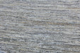 A close-up texture shot of a woven fabric or rug with horizontal stripes in gray, beige, and white.