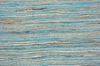 A close-up of a textured fabric or wallpaper pattern featuring horizontal wavy stripes in shades of blue, beige, and brown.