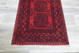 Red Afghan Turkman Bokhara hand-knotted wool rug featuring traditional repeating Gul medallions, 100 × 200 cm.Rugs Direct NZ