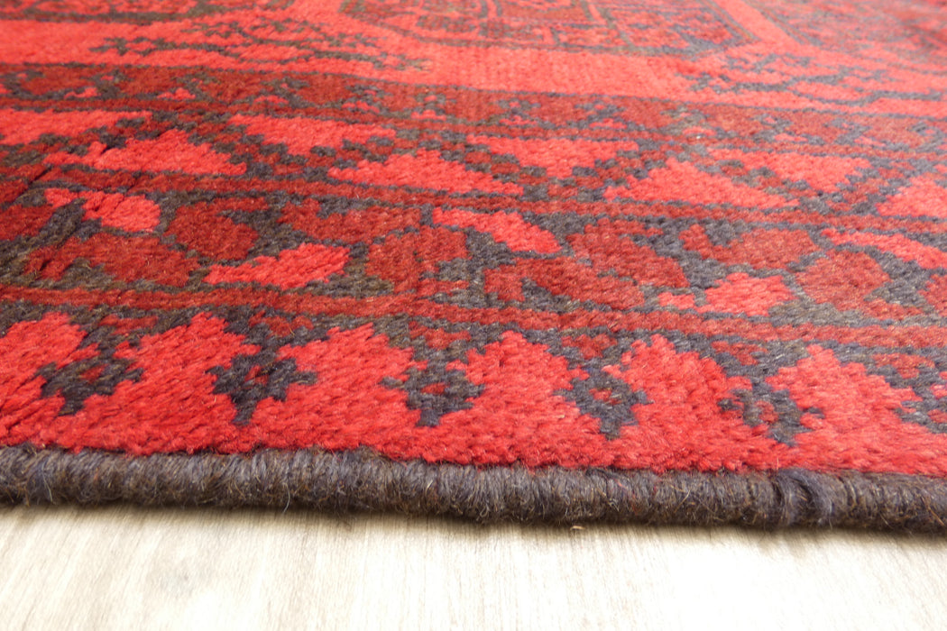 Red Afghan Turkman Bokhara hand-knotted wool rug featuring traditional repeating Gul medallions, 100 × 200 cm.Rugs Direct NZ