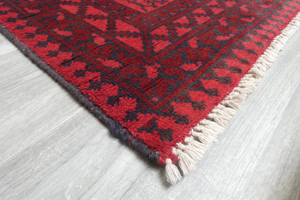 Red Afghan Turkman Bokhara hand-knotted wool rug featuring traditional repeating Gul medallions, 100 × 200 cm.Rugs Direct NZ