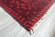 Red Afghan Turkman Bokhara hand-knotted wool rug featuring traditional repeating Gul medallions, 100 × 200 cm.Rugs Direct NZ