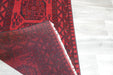 Red Afghan Turkman Bokhara hand-knotted wool rug featuring traditional repeating Gul medallions, 100 × 200 cm.Rugs Direct NZ