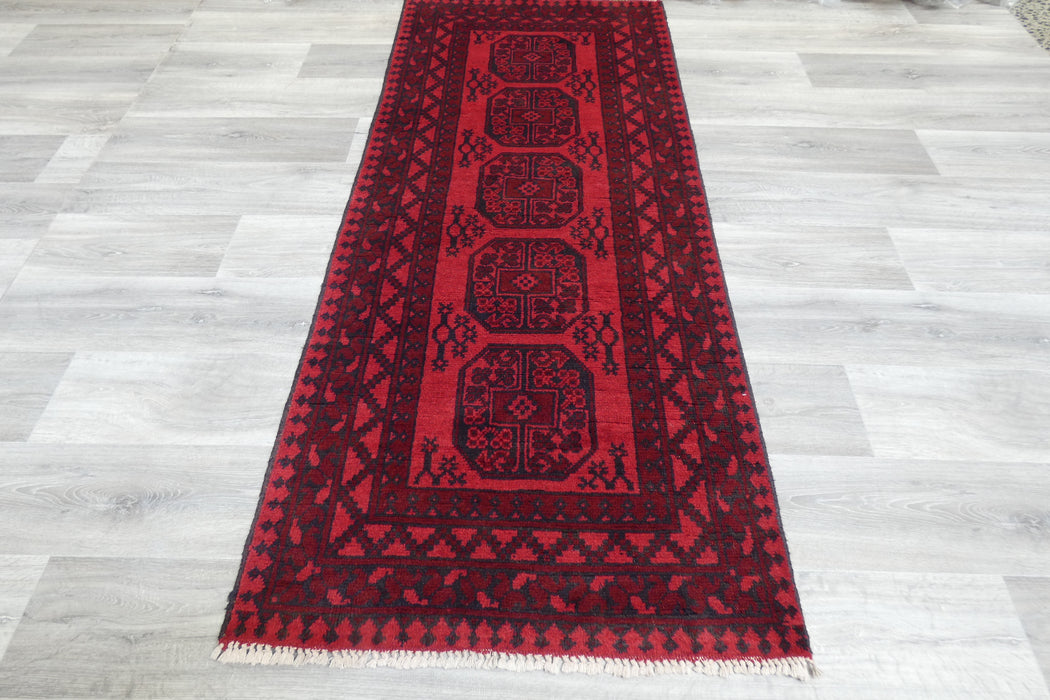 Red Afghan Turkman Bokhara hand-knotted wool rug featuring traditional repeating Gul medallions, 100 × 200 cm.Rugs Direct NZ