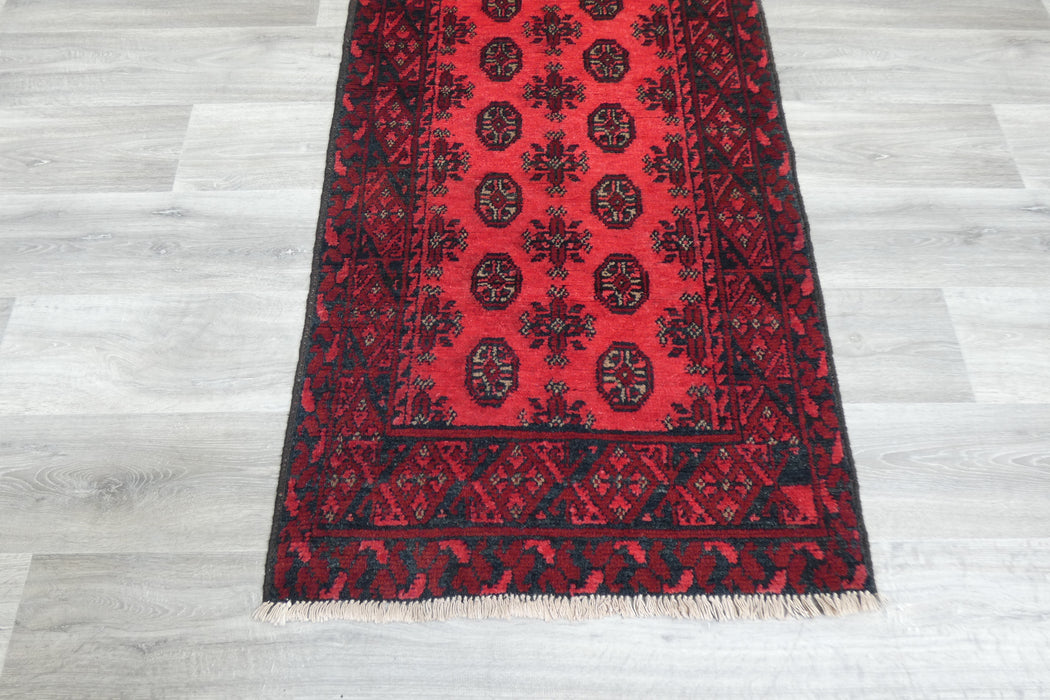 Red Afghan Turkman Bokhara hand-knotted wool rug featuring traditional repeating Gul medallions, .Rugs Direct NZ