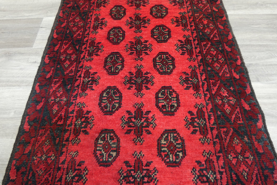Red Afghan Turkman Bokhara hand-knotted wool rug featuring traditional repeating Gul medallions, .Rugs Direct NZ