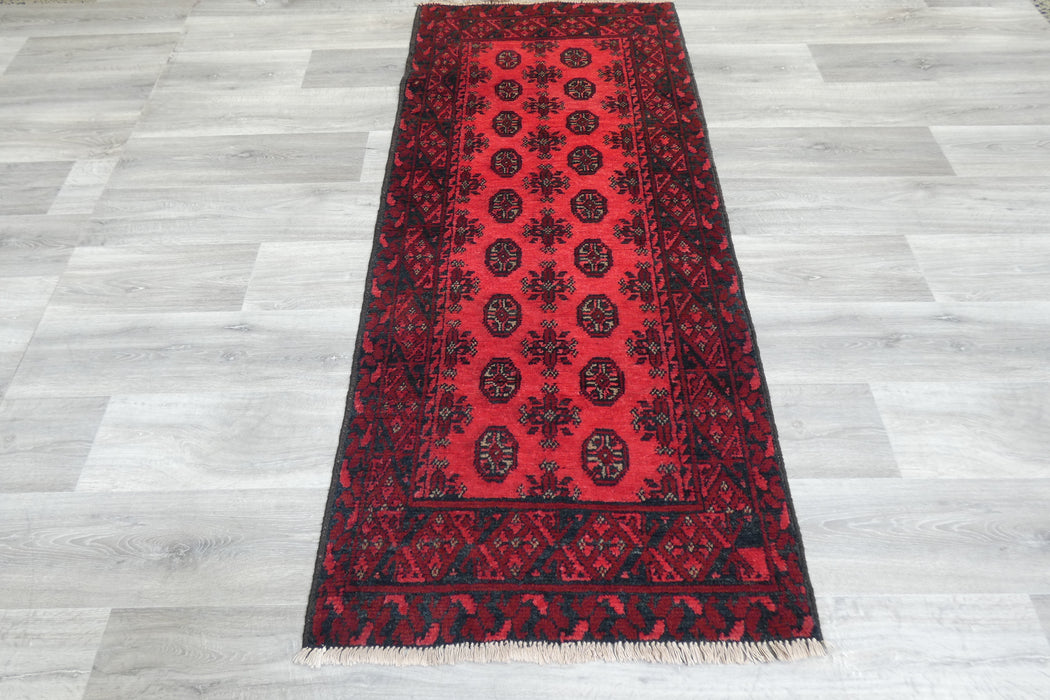 Red Afghan Turkman Bokhara hand-knotted wool rug featuring traditional repeating Gul medallions, 100 × 200 cm.Rugs Direct NZ