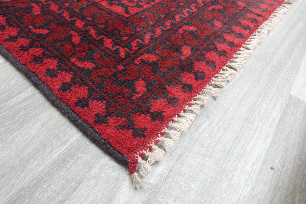 Red Afghan Turkman Bokhara hand-knotted wool rug featuring traditional repeating Gul medallions, 100 × 200 cm.Rugs Direct NZ