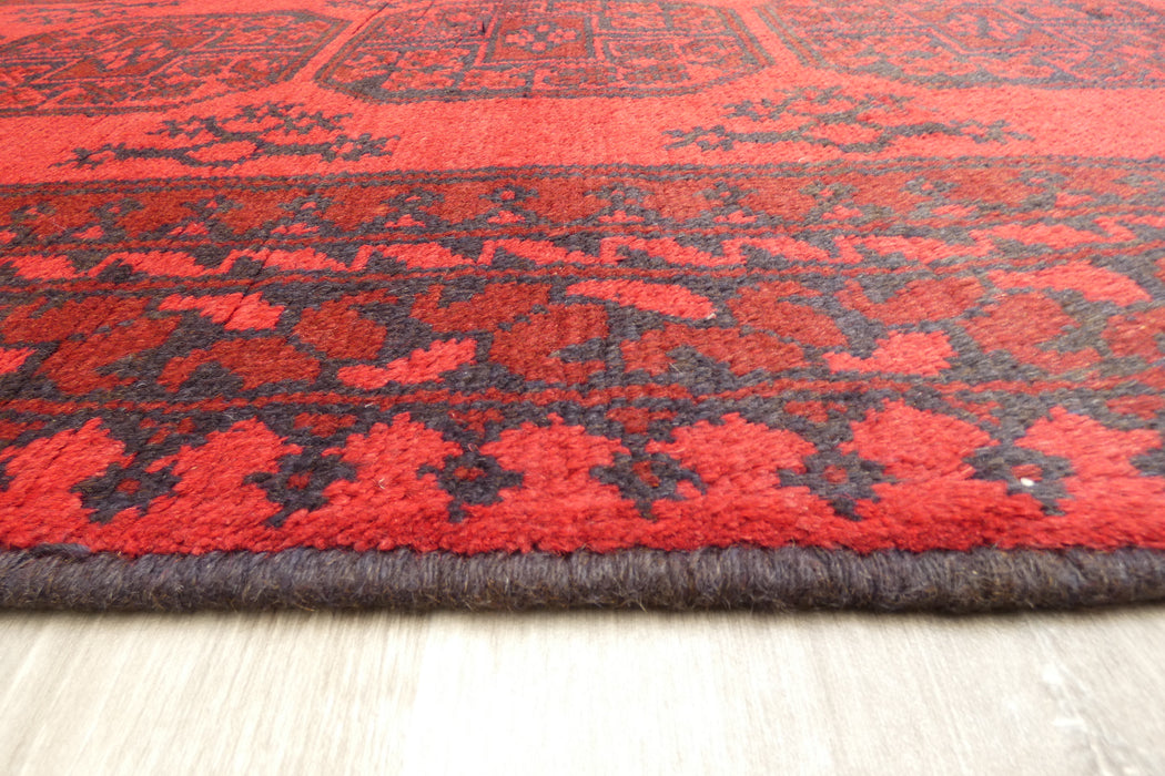 Red Afghan Turkman Bokhara hand-knotted wool rug featuring traditional repeating Gul medallions, 100 × 200 cm.Rugs Direct NZ