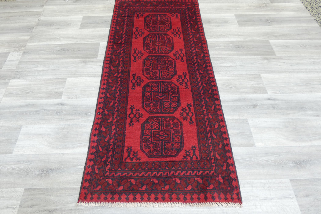 Red Afghan Turkman Bokhara hand-knotted wool rug featuring traditional repeating Gul medallions, 100 × 200 cm.Rugs Direct NZ