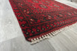 Red Afghan Turkman Bokhara hand-knotted wool hallway runner featuring repeating oval Gul medallions and traditional geometric borders.Rugs Direct NZ
