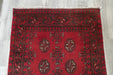 Red Afghan Turkman Bokhara hand-knotted wool hallway runner featuring repeating oval Gul medallions and traditional geometric borders.Rugs Direct NZ