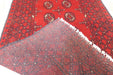 Red Afghan Turkman Bokhara hand-knotted wool hallway runner featuring repeating oval Gul medallions and traditional geometric borders. Rugs Direct NZ
