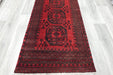 Red Afghan Turkman Bokhara hand-knotted wool hallway runner featuring repeating oval Gul medallions and traditional geometric borders.Rugs Direct NZ