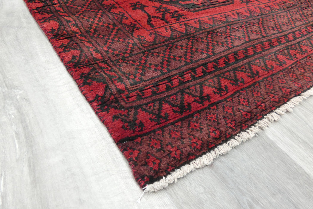Red Afghan Turkman Bokhara hand-knotted wool hallway runner featuring repeating oval Gul medallions and traditional geometric borders.Rugs Direct NZ