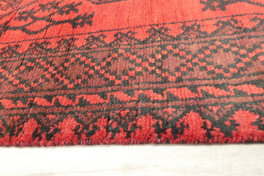 Red Afghan Turkman Bokhara hand-knotted wool hallway runner featuring repeating oval Gul medallions and traditional geometric borders.Rugs Direct NZ