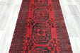 Red Afghan Turkman Bokhara hand-knotted wool hallway runner featuring repeating oval Gul medallions and traditional geometric borders.Rugs Direct NZ