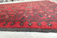 Red Afghan Turkman Bokhara hand-knotted wool hallway runner featuring repeating oval Gul medallions and traditional geometric borders.Rugs Direct NZ
