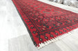 Red Afghan Turkman Bokhara hand-knotted wool hallway runner featuring repeating oval Gul medallions and traditional geometric borders.Rugs Direct NZ