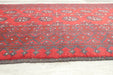Red Afghan Turkman Bokhara hand-knotted wool hallway runner featuring repeating oval Gul medallions and traditional geometric borders. Rugs Direct NZ